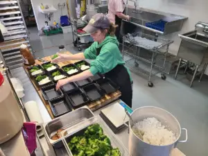Coast2Coast Culinary team packing meal prep containers in the Castle Rock kitchen