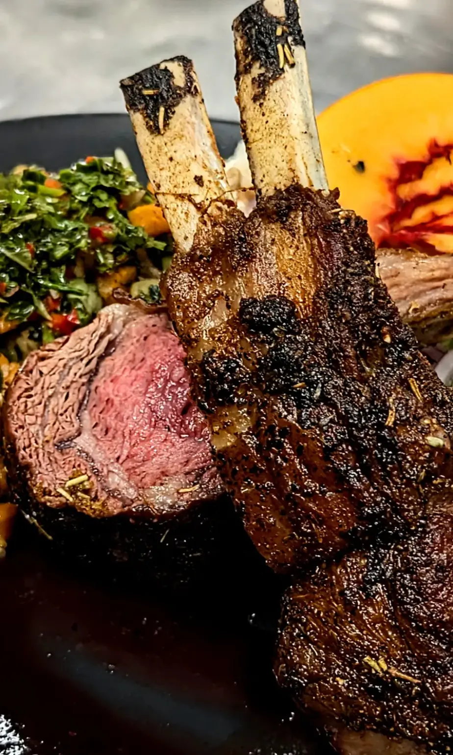 Grilled lamb chops with herb salad and roasted squash, plated for a private chef dinner